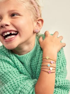 The Sweetheart Kids' Pisa Bracelet Set comes with five unique gold beaded bracelets. Each bracelet is complete with a heart bead in the center in a range of bright colors. Gift as a set to your little one, or split them apart to gift to them and all of their friends. READY TO GIFT: This item comes pre-packaged in a beautiful box.Please note: intended for children 3+ Trendy Heart Beads Jewelry For Birthday, Trendy Heart Beaded Jewelry For Birthday, Playful Heart-shaped Colorful Beads Jewelry, Sweet Multicolor Heart-shaped Jewelry, Playful Heart Beads Jewelry For Birthday, Playful Jewelry With Heart Beads, Gold Heart Stretch Bracelet For Friendship, Trendy Gold Friendship Bracelets For Valentine's Day, Playful Heart Beads Jewelry