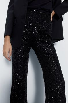 All-over sequin embellishments add glamorous texture 
 Flared silhouette from knee to hem creates an elongating shape 
 High-waisted fit with tonal stitching for a streamlined look 
Make a dazzling entrance in these scene-stealing sequin pants. The allover shimmering embellishments demand attention, while the flared leg creates an elongating silhouette. Pair with a fitted blazer and strappy heels for cocktail parties and nights out dancing. For drinks with friends, match with a silky camisole and wedges. The high-waisted fit creates a polished, put-together aesthetic. With their standout texture and flattering shape, these pants ensure all eyes will be on you for all the right reasons. Silky Camisole, Sequin Flare Pants, Girls Occasion Dresses, Sequin Pants, Christening Outfit, Bardot Dress, Tall Dresses, Black Tie Dress, Party Skirt