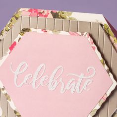 a pink card with the word celebrate written on it