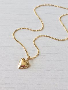 Gold Heart Necklace, Tiny Simple Heart Pendant, Delicate Gold Love Charm, Minimalist Gift for Girlfriend, Valentine's Day gift for women This dainty and delicate necklace features a tiny gold filled heart with dotted edges. The small heart pendant is suspended from a gold filled cable chain. This is a perfect layering necklace, simple and classic, you can wear this casually or dress it up. Ideal to give as a Valentine's Day Gift of an Anniversary gift for girlfriend of wife. About This Necklace Delicate Tiny Charm Necklace For Valentine's Day, Tiny Charm Necklaces For Valentine's Day, Simple Heart Necklace With Delicate Chain For Gift, Simple Charm Necklace With Delicate Chain For Valentine's Day, Dainty Heart Beads Charm Necklaces For Valentine's Day, Heart Shape Charm Necklace For Valentine's Day, Delicate Tiny Necklaces For Valentine's Day, Dainty Charm Necklace For Valentine's Day Gift, Feminine Necklace With Heart Charm For Gift