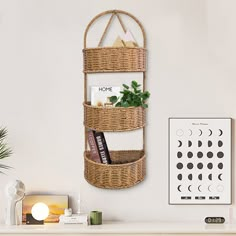 a wicker basket hanging on the wall next to a shelf with books and other items