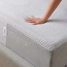 a woman's hand is on the top of an original mattress