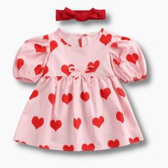 Kids can spread some love in this cute heart print dress. This lovely pink dress is perfect for Valentine's day or any special occasion. It features a headband, a heart-printed mini dress that's soft and breathable and a button closure at the back. Add to the style's charm, making it a cherished choice for picture-perfect moments with their loved ones. Material: CottonDresses Length: Knee-LengthCollar: O-neckBuilt-in Bra: NoSilhouette: A-LINE Cute Pink Dress With Sweetheart Neckline, Cute Pink Dress For Valentine's Day, Fitted Pink Heart Print Dress, Sweet Summer Dress With Sweetheart Neckline, Sweet Spring Dress With Sweetheart Neckline, Pink Fitted Dress With Heart Print, Fitted Pink Dress With Heart Print, Cute Pink Valentine's Day Dress, Pink Playful Short Sleeve Mini Dress