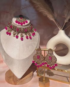 Capture the lush magnificence of India with this stunning Indian necklace set. From classic Pakistani jewelry to modern wedding jewelry designs, this necklace set will add a touch of sophistication to your Bollywood-inspired look. Accented with delicate pink choker stones and intricate polki earrings, this elegant piece of Indian jewelry is perfect for any eid or special occasion. Elevate your style and express yourself with this gorgeous Indian choker set. Elegant Kundan Bridal Sets For Eid, Elegant Bridal Sets For Eid Festivities, Elegant Bridal Sets For Eid, Elegant Jewelry For Wedding And Eid, Elegant Kundan Bridal Necklace For Eid, Elegant Festive Jewelry Set With Choker, Elegant Bridal Sets With Intricate Design For Party, Elegant Kundan Necklace For Eid, Elegant Round Kundan Necklace For Eid