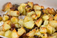 a white bowl filled with cooked potatoes on top of a table