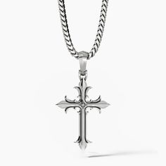 a unique sterling silver cross necklace hangs from a chain Silver Symbolic Cross Necklace, Classic Sterling Silver Cross Charm, Silver Cross Pendant Necklace, Symbolic Sterling Silver Cross Pendant, Symbolic Sterling Silver Cross Pendant Jewelry, Sterling Silver Cross Pendant Symbolic Jewelry, Spiritual Sterling Silver Cross Pendant Jewelry, Classic Engraved Crucifix Cross Necklace, Sterling Silver Oxidized Crucifix Necklace