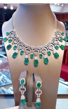 An exceptional Art Deco style parure, complete with earrings and necklace, so stunning and refined , a very piece of art. Necklace come in 18k gold with natural emeralds from Zambia, fine quality, in cabochon cut of 76,40 carats, and 641 pieces of natural diamonds of 8,68 carats, F color and VS clarity. Earrings come in 18k gold with 4 pieces of natural emeralds from Zambia, fine quality, of 19,93 carats, and 142 pieces of natural diamonds of 2,95 carats, round brilliant cut, F color and VS clar Formal White Gold Emerald Necklace With Jewels, Dazzling Jeweled Emerald Necklace For Formal Events, Exquisite Emerald Diamond Necklace, Exquisite Pear-shaped Emerald Necklace For Formal Occasions, Exquisite Jeweled Emerald Necklace For Anniversary, Luxury Emerald Necklace With Jewels For Formal Occasions, Luxury Emerald Necklace With Jewels For Formal Events, Luxury Emerald Necklace For Formal Events, Elegant Pear-shaped Emerald Necklace For Formal Occasions