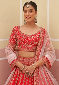 Capture the essence of eternal beauty with this Red Silk Embroidered Bridal Lehenga. Crafted from luxurious raw silk, it features intricate zardozi embellishments that combine silken threads, dabka, cutdana, and sequins. The meticulously embroidered blouse and matching double dupatta in red and blush pink hues complete this enchanting ensemble. Perfect for a bride looking for a timeless and captivating wedding dress. Composition : Lehenga and Blouse - Raw Silk, Dupatta - Soft Net Care: Dry Clean Festive Red Sets With Dori Work, Red Choli With Resham Embroidery, Red Festive Sets For Reception, Festive Red Sets For Reception, Red Sets With Zari Work For Traditional Ceremonies, Red Festive Choli, Red Wedding Sets For Navratri, Red Semi-stitched Sets With Zari Work, Traditional Zari Work Sets For Ceremony