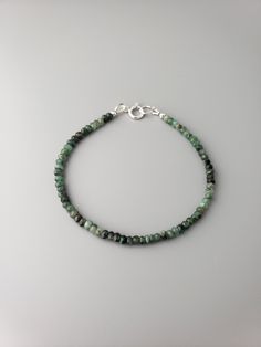 "This is untreated opaque faceted Emerald rondelles ranging in color from light to dark green with black inclusions. They are 3x2mm. The bracelet can be worn alone for a minimalistic look or in a stack with other bracelets.  It is 7\", but I can make any length required, just please leave me a note at the checkout. All items are strung on the high quality stringing wire.  Matching necklace  https://www.etsy.com/listing/1172237816/delicate-emerald-necklace-shaded Link to the shop  https://www.etsy.com/shop/CrystalRise" Dark Green Beaded Bracelet, Dark Green Bracelet, Minimalist Faceted Beads Rondelle Bracelets, Minimalist Rondelle Bracelets With Faceted Beads, Minimalist Bracelets With Faceted Rondelle Beads, Minimalist Rondelle Gemstone Beaded Bracelets, Minimalist Hand-strung Rondelle Beaded Bracelets, Minimalist Faceted Rondelle Beaded Bracelets, Minimalist Green Round Beads Bracelets