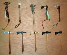 an assortment of different types of axes on a table with wood grained background