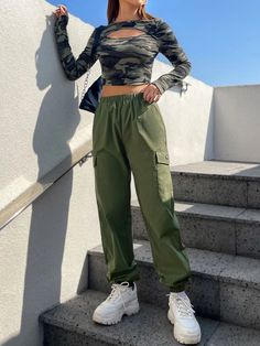 Step up your fashion game with this Camo Print Crop Tee and Cargo Pants set. The edgy camo print adds a rebellious flair, while the cut-out and patched details create a unique and eye-catching look. These pieces are made from a blend of knitted and woven fabric and offer comfort and style. Complete with long sleeves and multiple pockets, this regular-fit outfit is perfect for the fashion-forward individual. Details: Details: Cut Out, Patched, Pocket Neckline: Round Neck Pants Material: Woven Fab Spring Military Cargo Pants For Streetwear, Spring Military Style Cargo Pants For Streetwear, Spring Military Style Parachute Pants, Spring Military Parachute Pants, Casual Parachute Pants For Fall Streetwear, Casual Fall Parachute Pants For Streetwear, Trendy Stretch Parachute Pants For Streetwear, Hip Hop Parachute Pants For Fall, Stretch Camouflage Cargo Pants