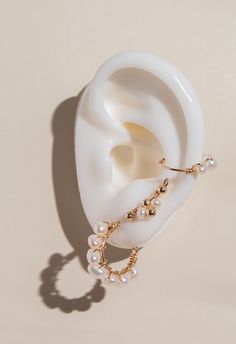 Indulge in luxury with our Maia Pearl Hoops. These handcrafted earrings feature stunning Maia pearls, exuding elegance and sophistication. Elevate any look with these exclusive hoops, perfect for any occasion. Feel like a true fashion icon with Maia Pearl Hoops. Details: Material: 14k Gold-Filled Gemstone: freshwater pearl Handcrafted Water Resistant Hypoallergenic and Tarnish resistant Luxury Pearl Jewelry With Pierced Design, Elegant Dangle Ear Cuff For Party, Elegant Hoop Clip-on Earrings, Elegant Gold Ear Cuff With Pearl Drop, Luxury Pearl Drop Clip-on Earrings, Elegant Hoop Wrap Earrings For Pierced Ears, Elegant Pearl Ear Cuff Single Earring, White Pearl Drop Ear Cuff For Wedding, Pearl White Pearl Jewelry For Pierced Ears