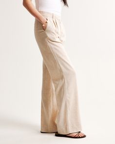 Our signature A&F Sloane Tailored Pant with a low rise, in our breezy linen-blend fabric, that's perfect for dressing up or down. Featuring figure-flattering pleating details, a functional fly and pockets and a partially elasticated waistband for ultimate adjustability. The intended length hits the bottom of a flat shoe. Please reference our size chart to determine your perfect size and inseam! Chic Trousers In Flax Color, Flax Colored Relaxed Fit Bottoms For Work, Relaxed Fit Flax Bottoms For Work, Neutral Linen Straight Pants, Spring Full-length Linen Bottoms, Full Length Linen Bottoms For Loungewear, Relaxed Fit Full Length Linen Bottoms, Relaxed Fit Full-length Linen Bottoms, Relaxed Fit Linen Bottoms Full Length