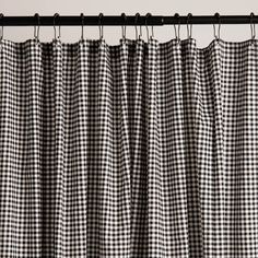 a black and white checkered curtain hanging from a metal rod