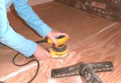 a person using a sander on the floor