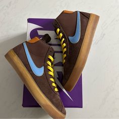 Elevate Your Sneaker Game With The Nike Sb Bruin High Dx4325-200 In Brown. These Unisex High-Top Sneakers Feature A Lace-Up Closure And Rubber Outsole, Perfect For Any Season And Occasion. The 100% Cashmere Upper Material, Coupled With Cushioned, Breathable, And Comfortable Features, Make These Shoes A Must-Have For Any Sneakerhead. With A Style Code Of Dx4325-200 And A Silhouette Of Nike Dunk Jewel Employee In House, These Sneakers Are A Rare Find. The Solid Pattern With Blue Character And A Bi Yellow Leather Skate Shoes With Laces, Nike Brown Skate Shoes With Contrast Sole, Nike Brown Skate Shoes For Skateboarding, Brown Nike Skate Shoes For Skateboarding, Brown Skate Shoes With Abzorb Midsole For Sports, Brown High-top Custom Sneakers For Skateboarding, Yellow High-top Leather Skate Shoes, Yellow Leather Skateboarding Sneakers, Brown Skate Shoes With Abzorb Midsole