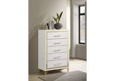 a white and gold chest of drawers in a room with a rug on the floor