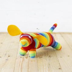 a colorful stuffed dog on a wooden floor