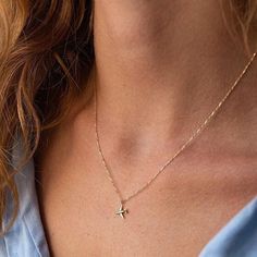 Charming piece of aviation jewelry - a delicate gold chain necklace featuring a dainty airplane pendant. This minimalist and stylish design is perfect for those who love travel and adventure. The yellow gold option adds a touch of elegance to the piece. It's an ideal gift for any aviation enthusiast, pilot, or traveler. The necklace is versatile and can be worn on any occasion. Get ready to take off with this beautiful and simple gold necklace! Material: 14K yellow gold Average weight: ≈ 1.32 g. Elegant Chain Necklace, Dainty Charm Necklace With Clavicle Chain And Cross Pendant, Dainty Cross Pendant Charm Necklace With Clavicle Chain, Dainty Cross Necklace For Gift, Charm Necklace Aesthetic, Necklace Airplane, Aviation Jewelry, Airplane Jewelry, Airplane Pendant