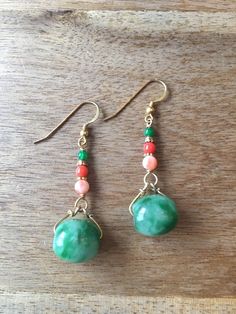 A pair of dangling earrings with two oval shaped green jade beads, decorated with genuine coral beads and green agate beads. - made with green jade rings, genuine coral beads and gold-plated 925 sterling silver beads, wire and hooks - approximately 57 mm / 2.24 inches length - approximately 15 mm / 0.59 inches in width and 13 mm / 0.51 inches in length of the oval shaped green jade Visit my shop for more: http://www.etsy.com/ca/shop/RitaCollection If you have any questions regarding the item or Handmade Jade Drop Earrings, Green Oval Jade Beads Jewelry, Green Oval Polished Beads Jewelry, Green Agate Teardrop Jewelry, Elegant Agate Gemstone Bead Earrings, Green Jade Earrings With Natural Stones, Bohemian Jade Gemstone Earrings, Bohemian Round Jade Earrings, Elegant Green Agate Earrings