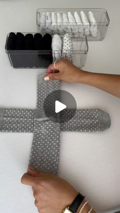 a person is making a cross out of fabric