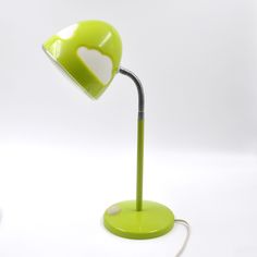 a green desk lamp with a white heart on the side and a black cord attached to it