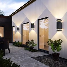 an exterior view of a modern house with outdoor lighting