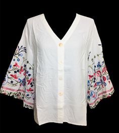 Beautiful cotton embroidered bell sleeve tunic top. Very light and breathable fabric.  An ideal tunic/top for Spring and Summer. Sleeves embellished with multi- color floral embroidery. Looks very elegant and perfect for evening wear, office wear, beach wear, resort wear. Size chart is posted with pics. Embroidered V-neck Top For Day Out, Spring V-neck Blouse With Chikankari Embroidery, Bohemian Spring Tops With 3/4 Sleeves, Spring Floral Embroidered V-neck Top, V-neck Tunic With Chikankari Embroidery For Spring, Spring Bohemian Top With Embroidered Hem, Spring Bohemian Blouse With Embroidered Hem, Floral Embroidered Top For Vacation In Fall, Floral Embroidered Top For Fall Vacation