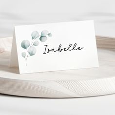 a card with the word toshifle on it sitting on top of a wooden tray