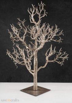 a white tree with no leaves in front of a black background