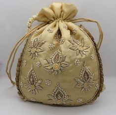 golden fabric kalash texture zardosi embroider wedding handmade handbag woman |embellish evening bag | indian potli bag purse handbagMaterial: SilkPackage Contents: As per quantity purchasedSize: 10” x 8”Designed with the heart, this beautiful Potli or batawa bag are eye catchy and made of premium material.Key Features:Embroidery art workThis potli is good match with both Indian and western outfits and are superb for wedding and festive partiesThis would be best complement to your designer saree Gold Evening Bag For Diwali Gift, Traditional Gold Embroidered Fabric For Formal Occasion, Bollywood Style Rectangular Potli Bag With Dori Work, Gold Raw Silk Embroidered Fabric With Gota Work, Gold Raw Silk Fabric With Gota Work, Gold Embroidered Potli Bag For Gift, Traditional Evening Bag With Resham Embroidery For Party, Festive Rectangular Potli Bag With Zari Work, Festive Gold Clutch With Zari Work