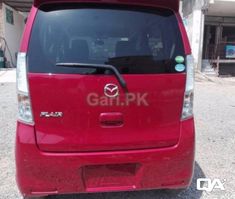 a red van parked in front of a building