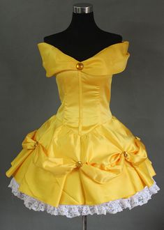 a yellow dress on a mannequin with white lace around the bust and bottom