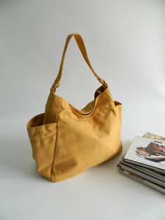 I like this design Minimalist Everyday Bags With Pockets, Minimalist Everyday Shoulder Bag With Pockets, Yellow Bag With Adjustable Strap For Everyday, Simple Large Capacity Hobo Bag For Travel, Simple Everyday Shoulder Bag With Pockets, Everyday Hobo Tote Bag With Pockets, Daily Use Weekender Shoulder Bag With Pockets, Yellow Large Capacity Hobo Bag For Travel, Simple Everyday Hobo Tote Bag