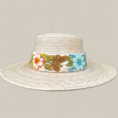 Our Mexican, high quality Artisal Palm Hat, comes with a removable hand embroidered band.  The band is embroidered by Female Artisans of the Andes in Perú.  This classic wide brim hat has sturdy weave to be used in the beach and all adventures in the sun.  Great sun protection.  The close-weave material in this product offers UPF 50+ which blocks 97.50% of the sun's UV rays. Hat Brim Measures 3 1/2" wide Crown If Hat Measures 4" Tall  One size Cream Handmade Adjustable Crochet Hat, Handmade Adjustable Cream Crochet Hat, Adjustable Handmade Cream Crochet Hat, Handmade Cream Crochet Hat With Adjustable Fit, Handmade Adjustable Bucket Straw Hat, Summer Embroidered Beige Hat, Cream Bohemian Crochet Hat With Adjustable Fit, Adjustable Multicolor Crochet Hat With Flat Brim, Adjustable Handwoven Bucket Hat With Short Brim