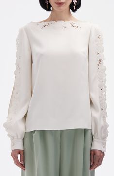 Intricate broderie anglaise details the bateau neck and open sleeves of this popover top crafted from stretch silk. Bateau neck Long sleeves with button cuffs Silk/elastane Dry clean Imported Designer Clothing Elegant Long Sleeve Top With Sheer Sleeves, Elegant Crew Neck Lace Top With Lace Trim, Elegant Silk Tops With Embroidered Sleeves, Elegant Long Sleeve Crew Neck Top For Spring, Elegant White Long Sleeve Top For Spring, Feminine Cream Blouse With Lace Cuffs, Elegant Embroidered Sleeve Top For Work, Silk Blouse With Embroidered Long Sleeves, Elegant Tops With Embroidered Sleeves For Work