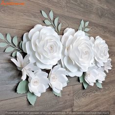 paper flowers are arranged on a wooden floor