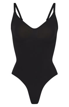 Find SKIMS Seamless Sculpt Thong Bodysuit on Editorialist. Updated for an even better fit, this fan-fave bodysuit from Kim Kardashian's SKIMS offers extra compression at the core and waist to cinch your natural shape. Strategically placed lines flatter your bust and provide definition, and the low back makes it easy to wear under a variety of outfits. Snap closure Scoop neck Adjustable straps Cotton-lined gusset 82% nylon, 18% spandex Machine wash, tumble dry Imported Slim Bodysuit, Body Suits, Birthday Stuff, Xmas List, Of Outfits, Dream Board, Natural Shapes, Christmas 2024, Low Back