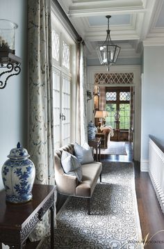 a living room filled with furniture and windows