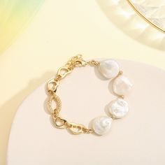 This exquisite Pearl Hollow Chain Bracelet will accessorize any outfit with timeless elegance. Crafted from 18k gold and delicate pearl chains, this bracelet exudes sophistication and style, making it the perfect addition to any luxury ensemble. DETAILS Plating: 18k Gold on Brass Materials:   18K Gold on Brass, Freshwater Pearl Measurements: Length: 6.30"(16.0cm) + Extender: 1.97"(5.0cm) Weight:  13.27g Note: It will be in stock in 7 business days! Elegant Metal Chain Bracelet With Pearl, Elegant Metal Bracelets With Pearl Chain, Elegant Metal Bracelet With Pearl Chain, Elegant Metal Chain Bracelet With Oyster Design, Elegant Gold Bracelet With Baroque Pearl, White Pearl Bracelet With Chain Detail, White Pearl Bracelet With Chain, Elegant Metal Pearl Bracelet As Gift, Elegant Metal Pearl Bracelet For Gift