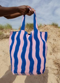 The oversized, multi-use Wave Tote is stylish enough to compliment any outfit and sturdy enough to carry your laptop, farmer's market finds, or beachside essentials. Crafted from 100% cotton canvas and hand block printed in bright pink and ocean blue by artisans in India, every tote is unique. Colorful Summer Beach Bags, Pink Cotton Summer Beach Bag, Multicolor Cotton Bag For Beach Season, Pink Cotton Canvas Bag For Summer, Pink Cotton Bags For Summer, Blue Cotton Beach Bag For Vacation, Pink Cotton Beach Bag For Vacation, Summer Multicolor Cotton Canvas Bag, Rectangular Cotton Beach Bag