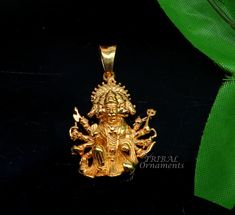 a gold pendant with an image of the god on it