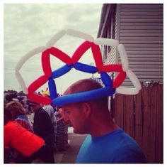 a man with a heart shaped balloon on his head