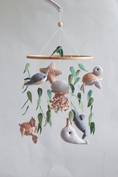 a crocheted mobile with sea animals hanging from it's sides and leaves