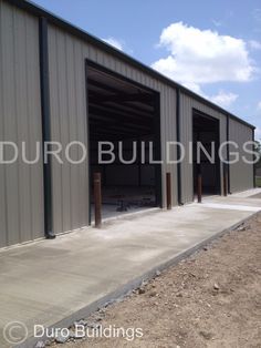 an industrial building with two garages and one door open to let in the light