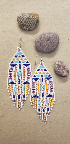 Summertime colors and bold patterns make up these fun earrings. Finished with sterling silver ear wires. Lightweight and cheerful. White Beaded Artsy Jewelry, Artsy White Beaded Jewelry, Artsy Multicolor Beaded Earrings As Gift, White Artsy Earrings With Ear Wire, Artsy White Earrings With Ear Wire, White Artsy Drop Earrings, Artsy White Pierced Earrings, Artsy White Drop Earrings, Artsy White Earrings