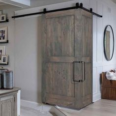 a large wooden cabinet sitting in the corner of a room with pictures on the wall