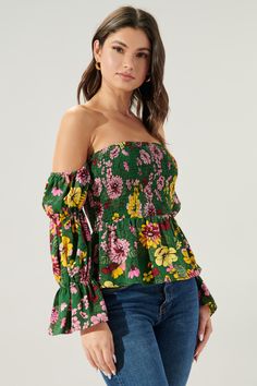 Autumn is in full bloom in the Everly Floral Off the Shoulder Smocked Peplum Top. Perfect for warmer autumn days, this top features a smocked bodice with a peplum waist. Smocked off the shoulder sleeves are attached. Complete the look with light wide leg pants and strappy heels for a flirty look.- Smocked bodice- Off the shoulder- Smocked sleeves- Peplum- Color: Green MultiSize + Fit - Model is 5'9" and wearing size XS- Measurements taken from size S - Chest: 29"- Length: 31 1/2" fabricSelf: 100 Off-shoulder Top With Smocked Bodice For Fall, Smocked Cuffs Tops For Day Out In Fall, Smocked Cuffs Tops For Fall Day Out, Tops With Smocked Cuffs For Fall Day Out, Fall Tops With Smocked Cuffs For Day Out, Spring Floral Print Blouse For Gatherings, Spring Multicolor Smocked Top With Smocked Back, Off-shoulder Smocked Bodice Top For Fall, Floral Print Blouse For Spring Gatherings