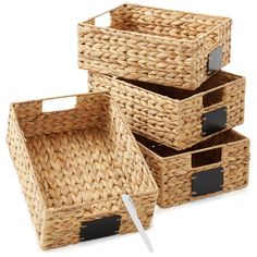 three wicker baskets with labels on them and one has a knife in the middle