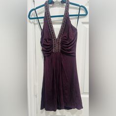 This Nwot, Sky Dress Is A Size Medium. The Color Is A Deep Plum. Accent Ruching Around Bust Line. Embellished With Purple Jewels And Pearls, That Creates A Low V Neck And Wraps All The Way Around The Neck Line. Adjustable Clasp Closure. Backless Approximate Measurements: Pit To Pit 13”, Length 29”. Never Been Worn, Stunningly Sexy Dress! Embellished V-neck Dress For Date Night, Embellished V-neck Mini Dress For Date Night, Embellished Halter Neck Dress For Date Night, Chic Embellished Halter Neck Dress, Embellished Halter Neck Cocktail Dress, Embellished Sleeveless Halter Dress For Night Out, Halter Neck Embellished Mini Dress For Cocktail, Embellished Halter Neck Mini Dress For Date Night, Embellished Halter Neck Cocktail Mini Dress